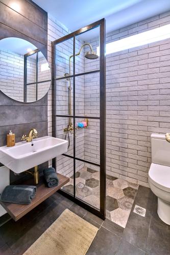 a bathroom with a shower and a sink and a toilet at Corali House in Stavros