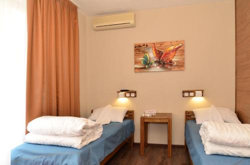 a hotel room with two beds and a table at Music Hostel in Poltava
