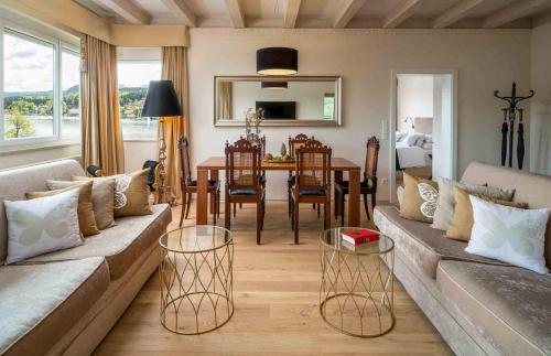 a living room with a couch and a table at Seehotel Europa Resort in Velden am Wörthersee