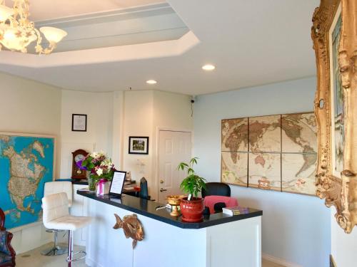 a room with a desk with a map on the wall at Casa Grande Inn in Qualicum Beach