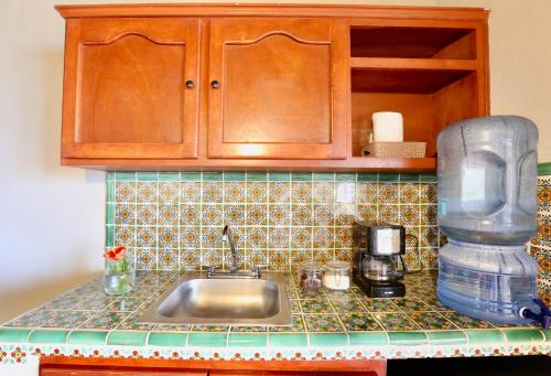 a kitchen counter with a sink and a mixer at Cerritos Surf Town - Beach Front Property in El Pescadero