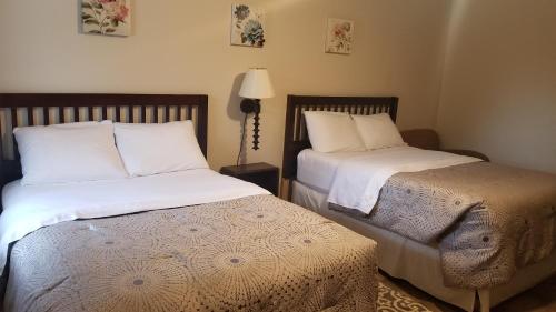 two beds sitting next to each other in a bedroom at Rothesay Motel in Rothesay