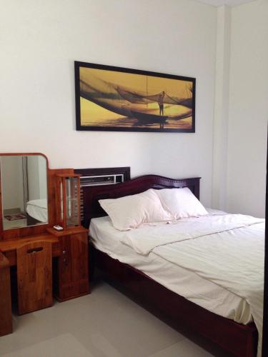 a bedroom with a bed and a picture of a plane on the wall at Hoi An beach house in Hoi An