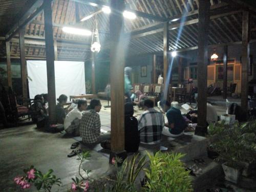 a group of people sitting around in a room at Pendopo Kayuwanan Syariah Near Terminal Giwangan in Yogyakarta