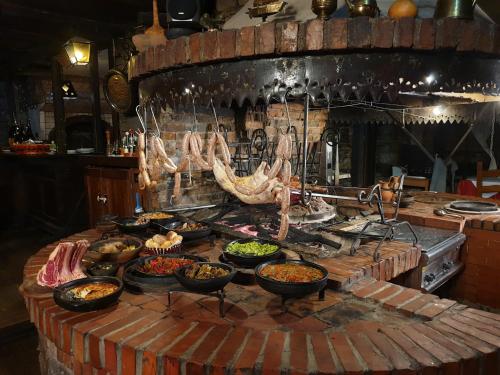 a kitchen with many bowls of food on a table at Hotel Restaurant Bujtina e Gjelit in Tirana