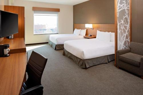 a hotel room with two beds and a television at Hyatt Place Glendale/Los Angeles in Glendale