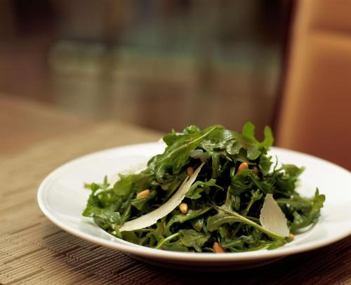 a white plate with a salad on a table at Hyatt Regency Monterey Hotel and Spa in Monterey