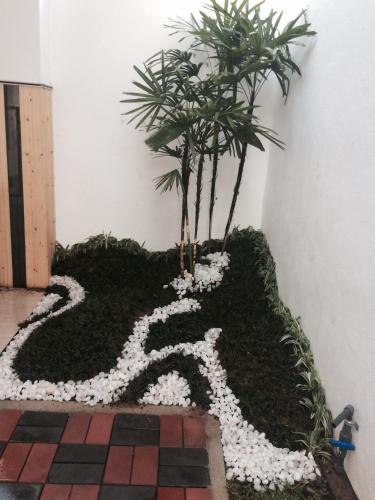 a rug with two palm trees in a room at Baywings Rooms in Arugam Bay