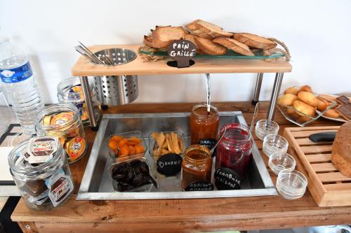 a table with a tray of sandwiches and bread at Le Fangassier in Saintes-Maries-de-la-Mer