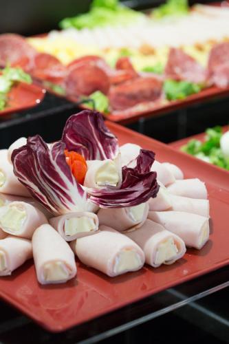a red plate of food with different types of food at Floris Hotel in Rome