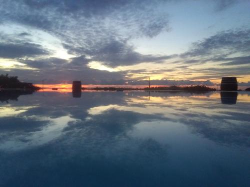 a reflection of the sky in a body of water at Agriturismo Baglio Donnafranca Wine Resort in Marsala