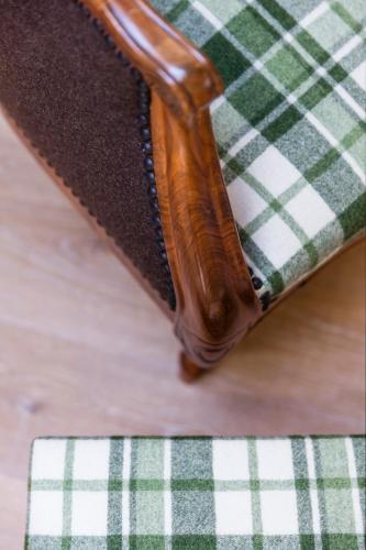 a close up of a table with a green and white table cloth at Neuhof Gäste-& Schokohaus in Appenzell
