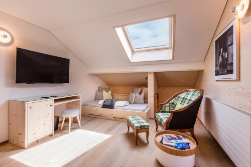 a tiny house with a bed and a window at Neuhof Gäste-& Schokohaus in Appenzell