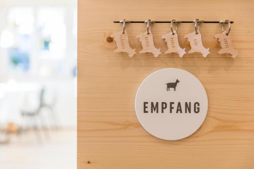 a mirror hanging on a wall with the words emerging at Neuhof Gäste-& Schokohaus in Appenzell