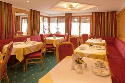 a dining room with tables and chairs and tablesktop at Pension Inge in Sankt Anton am Arlberg