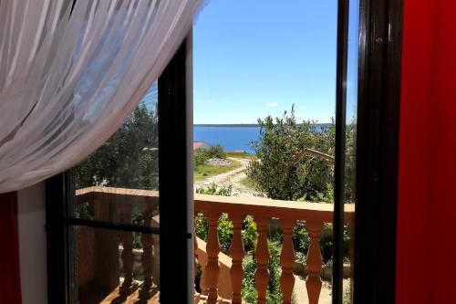a view of the ocean from a window at Apartments Anka in Rtina