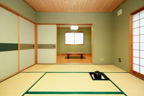 an empty room with a table in the middle at Ryokan ASAKUSA-chaka- by Tranova in Tokyo
