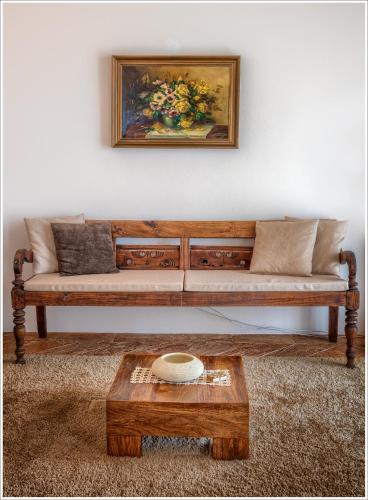 a living room with a couch and a painting on the wall at Villa Aquarius - Larihome A08 in Vercana