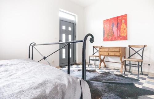 a bedroom with a bed and a table and chairs at Apartments Castello Risano in Risan