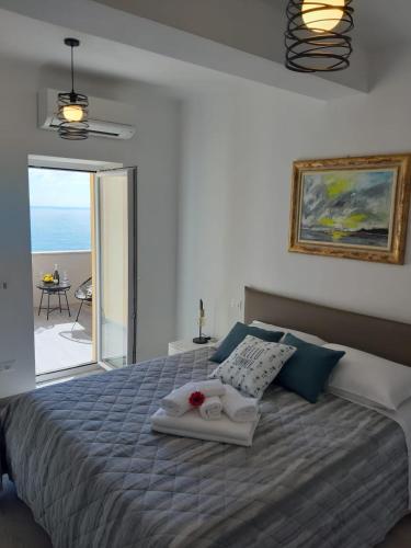 a bedroom with a bed with a view of the ocean at Alex Room in Manarola