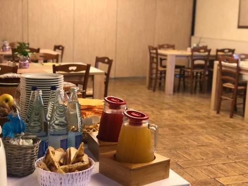a table with food and condiments on top of it at Hotel La Foresteria in Abbadia di Fiastra