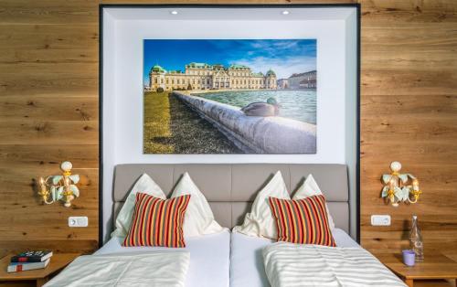 ein Schlafzimmer mit einem Bett mit einem Bild an der Wand in der Unterkunft Landgasthof zur Linde Laaben in Laaben