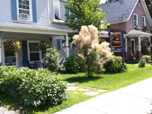 a house with bushes in the front yard at Au Coeur De Magog in Magog-Orford