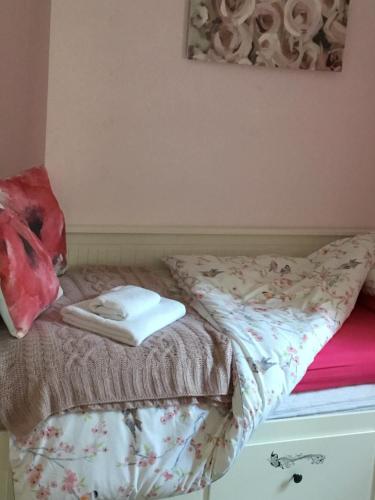 a bed with two towels on top of it at 2 Emma Place in Bodmin