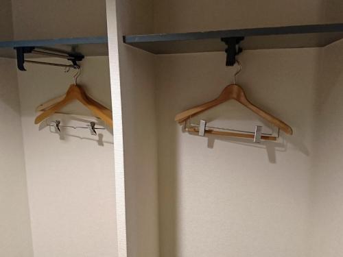 two hangers on a wall in a room at Hotel Oaks Early-Bird Osaka Morinomiya/ Vacation STAY 28787 in Osaka