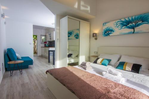 a bedroom with a large bed and a mirror at Apartments Birimac in Pula