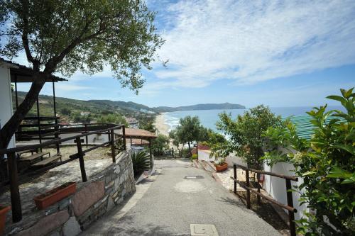 a walkway leading down to the ocean from a house at Residence Punta Cilento in Pisciotta