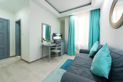 a living room with a couch and a table at Relax Comfort Suites Hotel in Bucharest