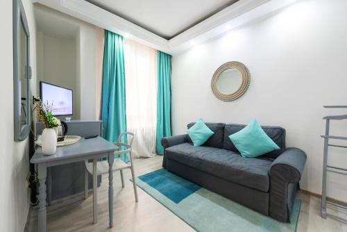 a living room with a couch and a table at Relax Comfort Suites Hotel in Bucharest