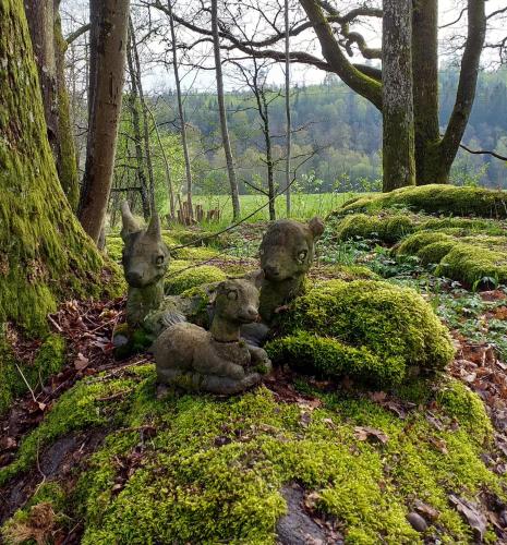 a group of stuffed animals sitting on a moss covered forest at Villa Ekegården in Härryda