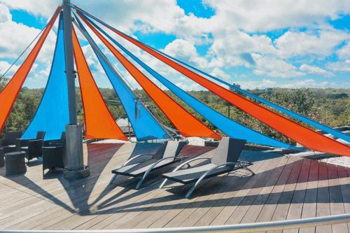 a boat with orange and blue sails on a deck at Luz_ita Sunshine Villa in Uluwatu