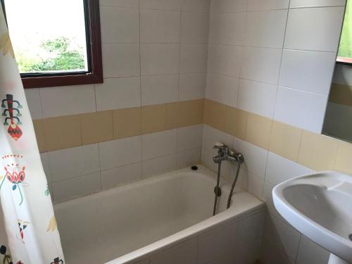 a bathroom with a bath tub and a sink at Entrerrobles in Valdeavellano de Tera