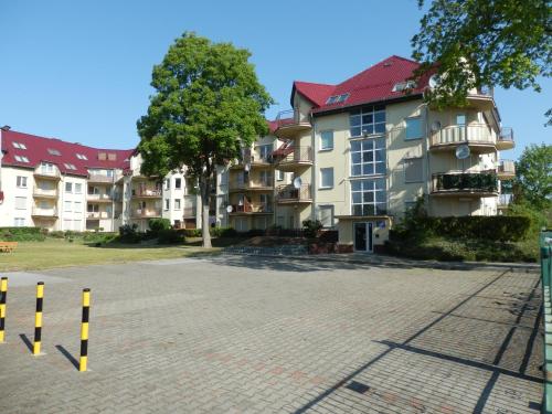 a large apartment building on a brick street at Apartament Dziwnów in Dziwnów