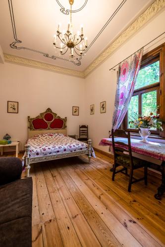 a bedroom with a bed and a piano at Veranda Suite in Liepāja