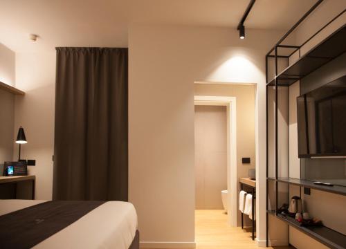 a hotel room with a bed and a television at Meg Lifestyle Hotel & Apartaments in Riccione