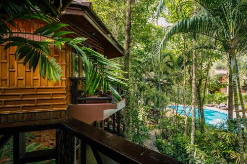 a resort with a swimming pool in the jungle at Phu Pha Aonang Resort & Spa in Ao Nang Beach