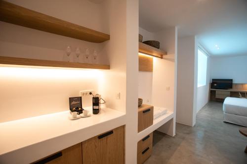 a kitchen with a counter and a living room at Melidonia Suites in Akrotiri