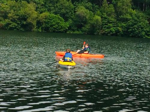 two people are in kayaks on a lake at Clear Pond Suite in Plymouth