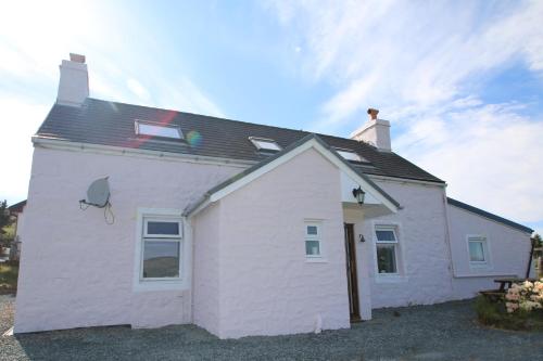 a white house with a black roof at Arle Farmhouse in Tobermory