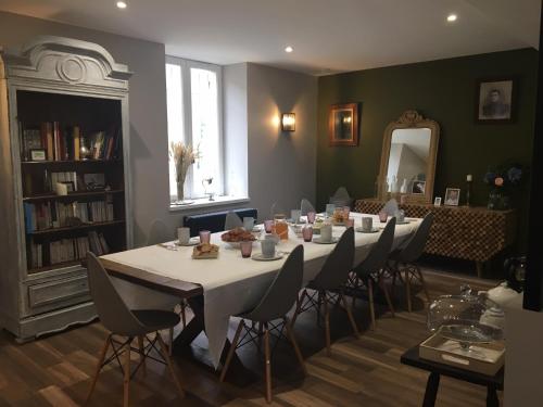 a dining room with a long table and chairs at La Billebaude in Mulsans