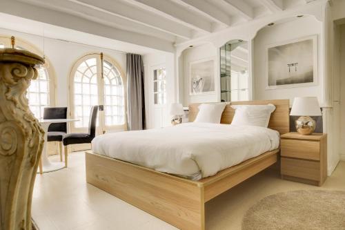 a bedroom with a large bed and a desk at Les Chambres Lune in Saint-Aignan