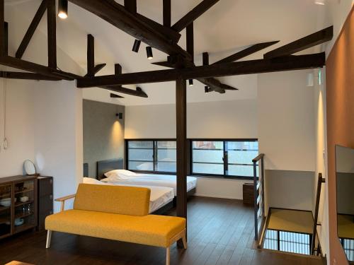 a bedroom with a bed and a chair at Kanazawa Bettei Yuan in Kanazawa