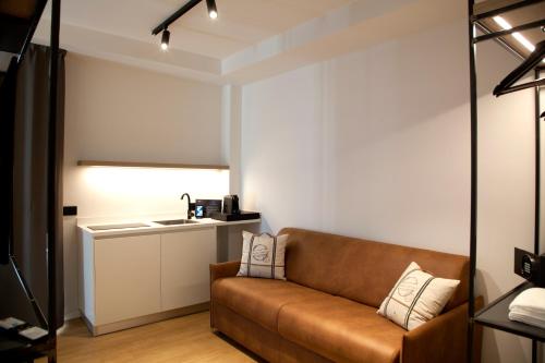a living room with a couch and a sink at Meg Lifestyle Hotel & Apartaments in Riccione