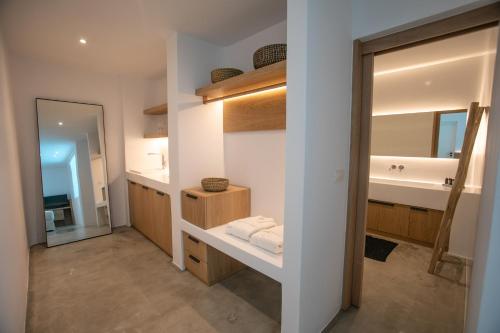 a bathroom with a sink and a mirror at Melidonia Suites in Akrotiri