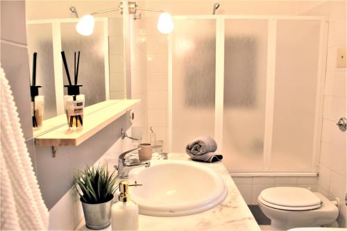 a white bathroom with a sink and a toilet at B&B Bandiera 77 in Palermo