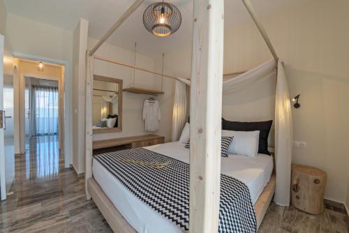 a bedroom with a four poster bed with a canopy at Plakias Family Apartment in Plakias